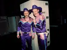 Sebastian Brandes and Jan-Christoph Gockel in matching purple cowboy costumes backstage at Wer immer hofft, stirbt singend