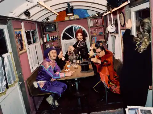 Sebastian Brandes, Johanna Eiworth and Dennis Fell-Hernandez Jan-Christoph Gockel gathered around a table backstage at Wer immer hofft, stirbt singend