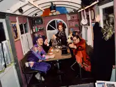 Sebastian Brandes, Johanna Eiworth and Dennis Fell-Hernandez Jan-Christoph Gockel gathered around a table backstage at Wer immer hofft, stirbt singend