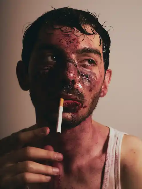Enes Sahin in makeup with a cigarette at the Otto-Falckenberg-Schule