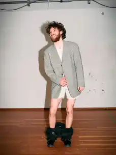 Portrait of Marlon Bienert laughing with his pants down on stage
