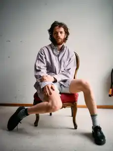 Portrait of Marlon Bienert in shorts sitting in a chair